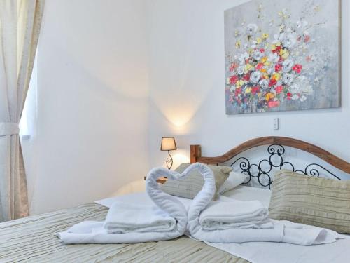 a bed with two swans made out of towels at Marinic Comfortable holiday residence in Zadar