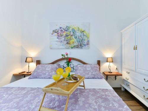 a bedroom with a bed and a table with drinks on it at Marinic Comfortable holiday residence in Zadar