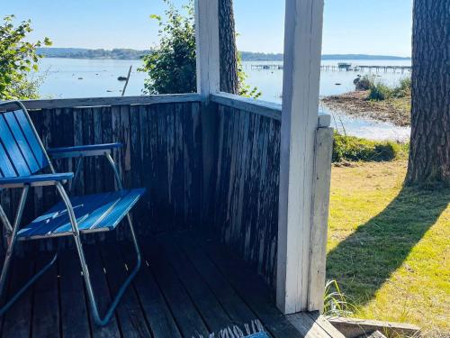 a blue chair sitting on the porch of a house at 4 person holiday home in ONSALA in Onsala
