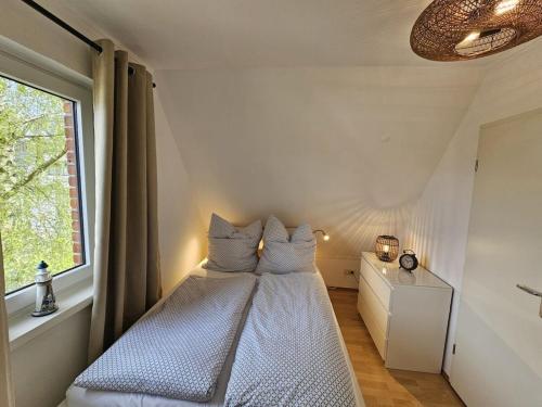 a bed in a room with a window at Raphael - "Roger Moore" in Timmendorfer Strand