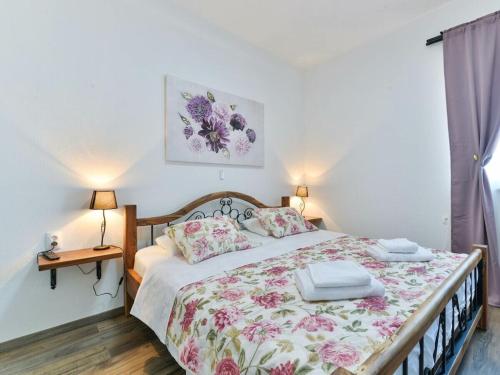 a bedroom with a bed with two towels on it at Marinic Comfortable holiday residence in Zadar