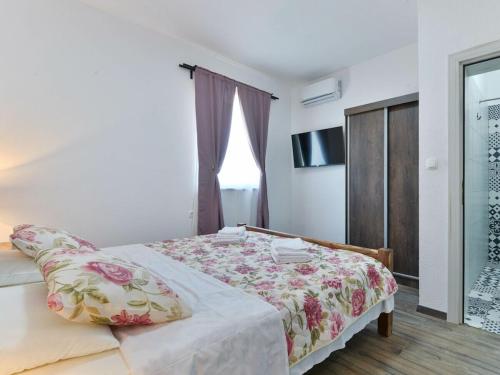 a bedroom with a bed and a window and a shower at Marinic Comfortable holiday residence in Zadar