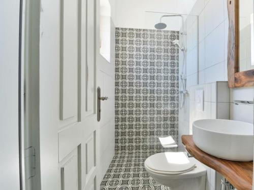 a white bathroom with a sink and a toilet at Marinic Comfortable holiday residence in Zadar