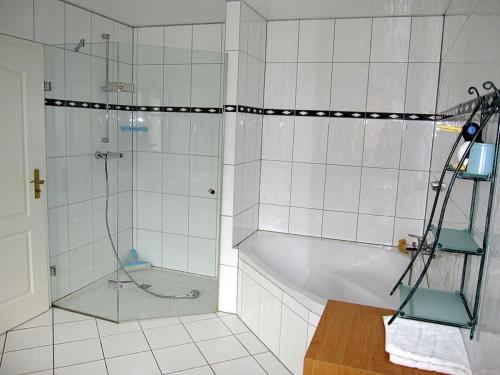 a bathroom with a shower and a bath tub at Brentel family Comfortable holiday residence in Vehlin