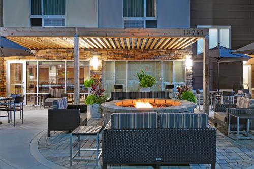 a patio with a fountain and tables and chairs at TownePlace Suites by Marriott Jacksonville East in Jacksonville