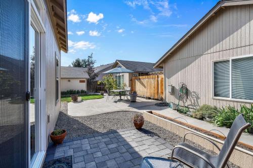 a patio with a table and a fence at Scrubjay Suite - Meredith Lodging in Redmond