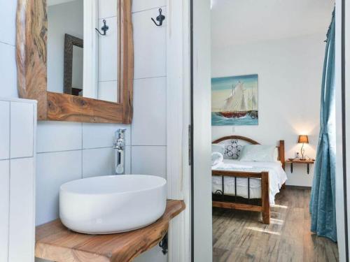 a bathroom with a tub and a bedroom with a bed at Marinic Comfortable holiday residence in Zadar