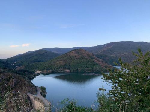 a large lake in the middle of a mountain at La Patouille Comfortable holiday residence in Aujac