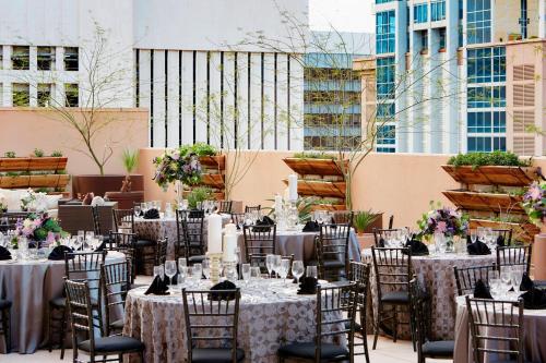 a group of tables and chairs with flowers on them at Renaissance Phoenix Downtown Hotel in Phoenix