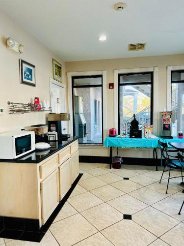 a kitchen with a table and a blue counter top at Magnolia Inn and Suites in Magnolia