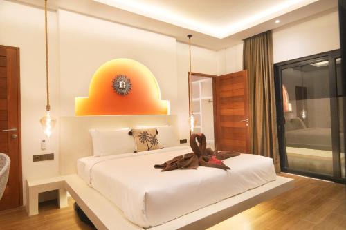 a bedroom with a large white bed in a room at Kamalie Bali Luxury in Tanah Lot