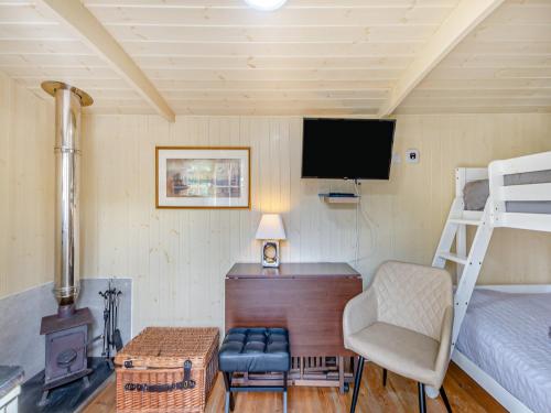 a bedroom with a bunk bed and a desk with a chair at Williams Hide - Uk43571 in Haltwhistle