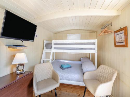 a small room with a bunk bed and two chairs at Williams Hide - Uk43571 in Haltwhistle