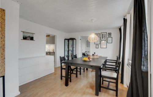 a dining room with a black table and chairs at Stunning Home In Vestervig With Wifi in Vestervig