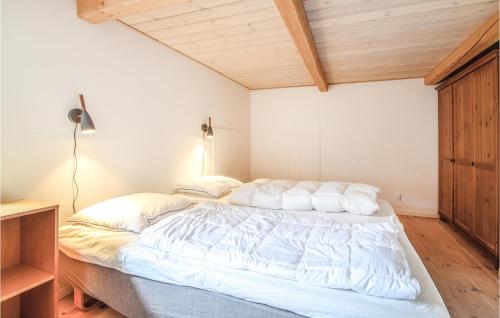 a bedroom with a bed with white sheets and pillows at Lovely Home In Silkeborg in Silkeborg