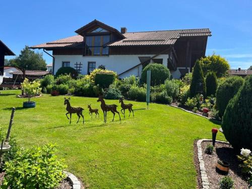 a group of four horses running in a yard at Sonnenblick Comfortable holiday residence in Grafenwiesen