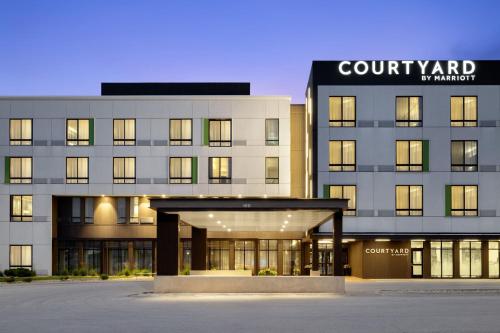 a large building with a court yard in front of it at Courtyard by Marriott Omaha East/Council Bluffs, IA in Council Bluffs