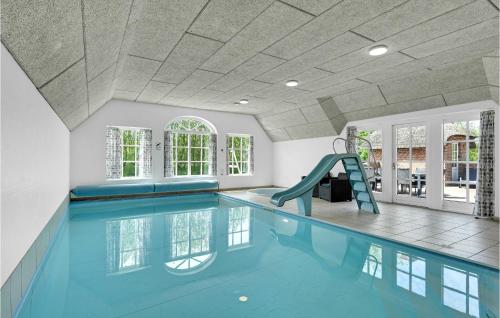 a swimming pool with a slide in a house at Stunning Home In Ulfborg With Sauna in Ulfborg