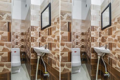 a bathroom with two sinks and two mirrors at Hotel O Sun View in Ludhiana