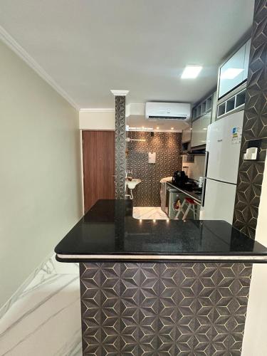 a kitchen with a black counter top in a room at Apartamento confortável in Boa Vista