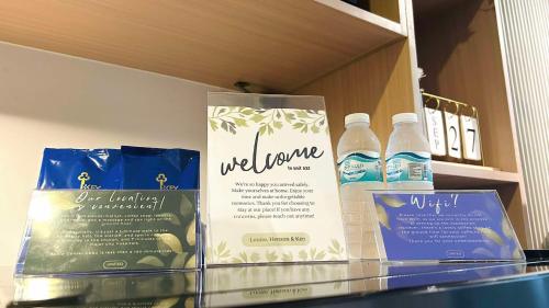 two bottles of water are sitting on a shelf at Modern Studio Urban Comfort in Cebu City