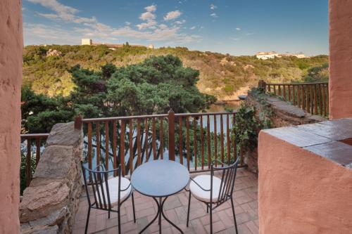 a table and chairs on a balcony with a view at Cervo Hotel,Costa Smeralda Resort in Porto Cervo