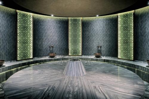 a lobby with a large tub with candles in it at JW Marriott Marquis Hotel Dubai in Dubai