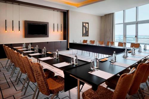 a conference room with a long table and chairs at JW Marriott Marquis Hotel Dubai in Dubai
