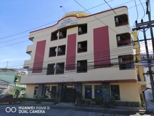 a building with pink and white at Suwanna Hotel krabi town in Krabi
