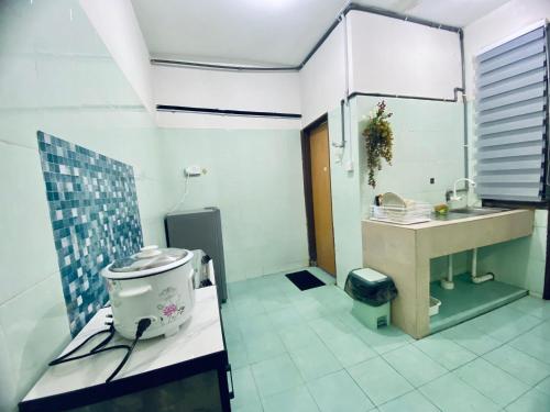 a bathroom with a sink and a toilet at Wadi Iman Homestay in Kota Bharu