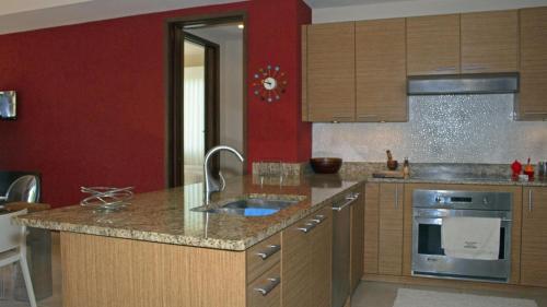 a kitchen with wooden cabinets and a counter top at Villa in Red in Rio Grande