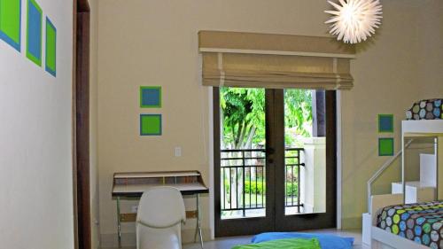a room with a bedroom with a sliding glass door at Villa in Red in Rio Grande