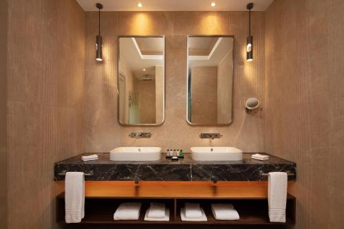 a bathroom with two sinks and a large mirror at Sheraton Istanbul Levent in Istanbul
