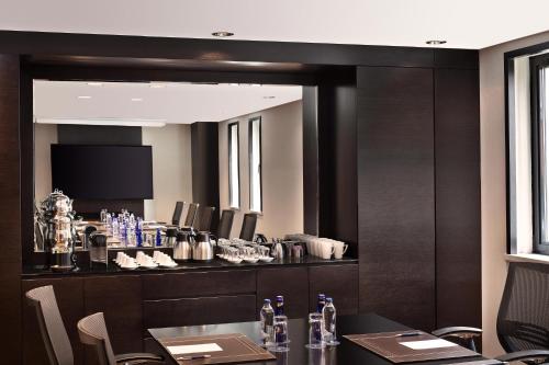 a dining room with a table and a mirror at Sheraton Istanbul Levent in Istanbul