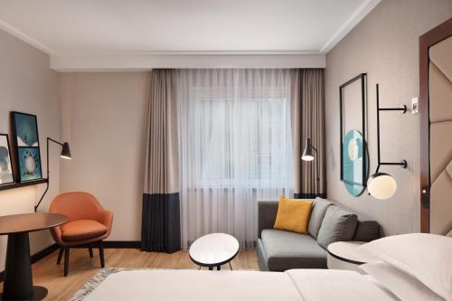 a living room with a couch and a table at Sheraton Istanbul Levent in Istanbul