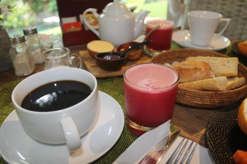 a table with a cup of coffee and a plate of food at Kamalie Bali Luxury in Tanah Lot