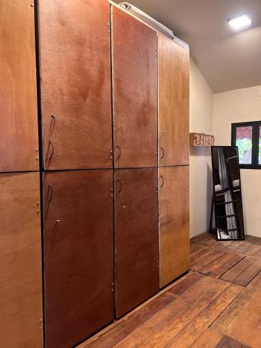 a large wooden cabinet in a room with wood floors at Hostal Juárez Puerto Escondido in Brisas de Zicatela