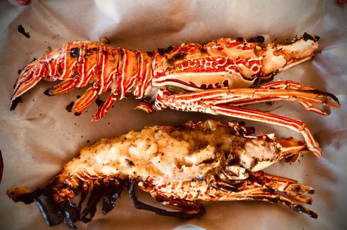 two pieces of seafood sitting on top of paper at Kamalie Bali Luxury in Tanah Lot