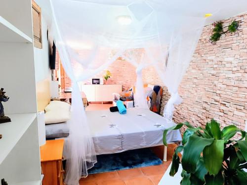 a room with a bed and a brick wall at Villa Margarita in Santa Lucía