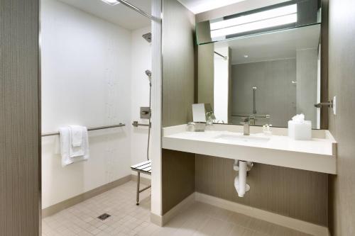 a bathroom with a sink and a mirror at Courtyard by Marriott Los Angeles LAX/Hawthorne in Hawthorne