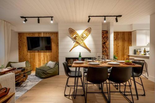 a living room with a dining room table with chairs at Powder & Pines Boutique Apartment in Whistler