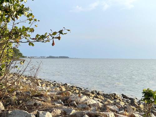 a group of rocks on the shore of a body of water at Homestay & Pool Laman Sri Aman Pontian in Pontian Besar