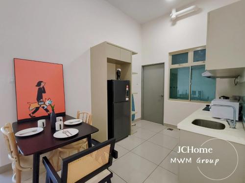 a kitchen with a table and a refrigerator in it at Manhattan Austin By JC Home in Johor Bahru