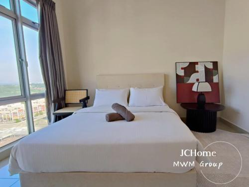 a bedroom with a white bed with a large window at Manhattan Austin By JC Home in Johor Bahru