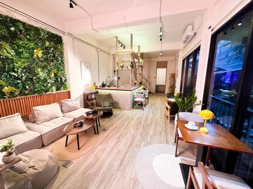 a living room with a couch and a table at Bangkok Neighborhood Hostel in Bangkok