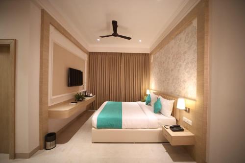 a bedroom with a bed and a ceiling fan at raghukul sadan in Faizābād
