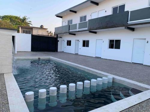 a pool of water in front of a house at Las lomas in Ursulo Galván