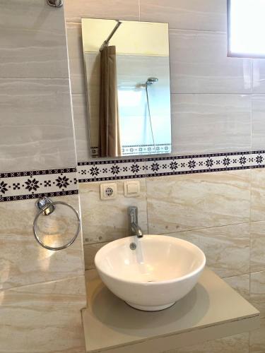 a bathroom with a white sink and a mirror at Bagus Homestay in Ubud