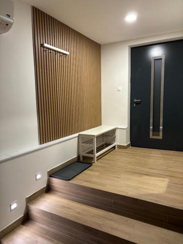 an empty room with a door and a stair case at City Apartment - Michalovce in Michalovce