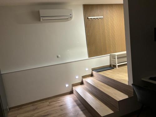 a hallway with stairs and a mirror in a room at City Apartment - Michalovce in Michalovce